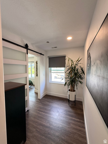 965 North 800 East Springville, UT 84663 - Photo 29 of 46 Unfurnished room featuring a barn door, dark wood-style flooring, recessed lighting, and a textured ceiling