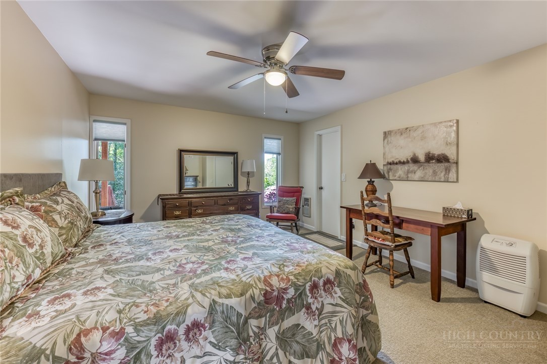 174 Spruce Pine Road Newland, NC 28657 - Photo 27 of 50 a bedroom with a bed and a chandelier
