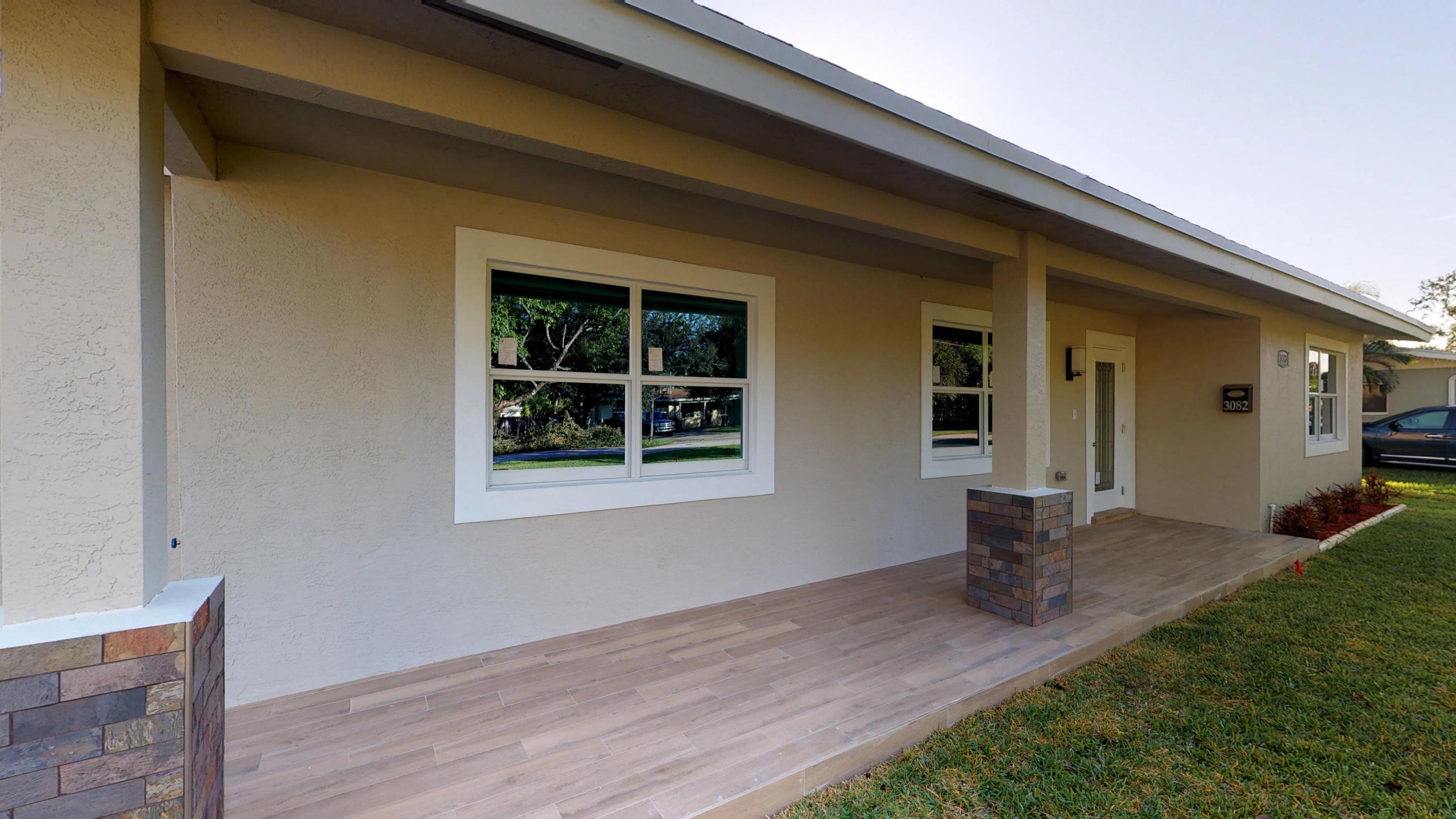3082 Rostan Lane Palm Springs, FL 33461 - Photo 1 of 20 a front view of a house with a yard