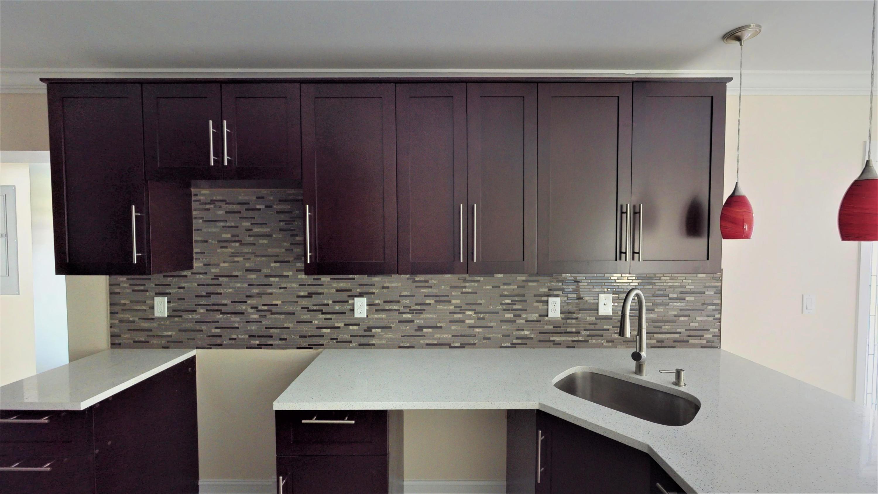 3082 Rostan Lane Palm Springs, FL 33461 - Photo 4 of 20 a kitchen with a sink and cabinets