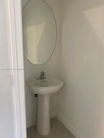 a view of kitchen with kitchen island white cabinets and stainless steel appliances