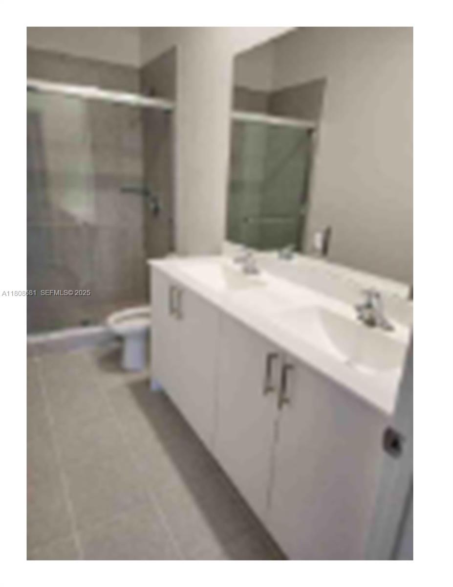 12891 Southwest 243rd Terrace Homestead, FL 33031 - Photo 8 of 18 a bathroom with a sink a toilet and shower