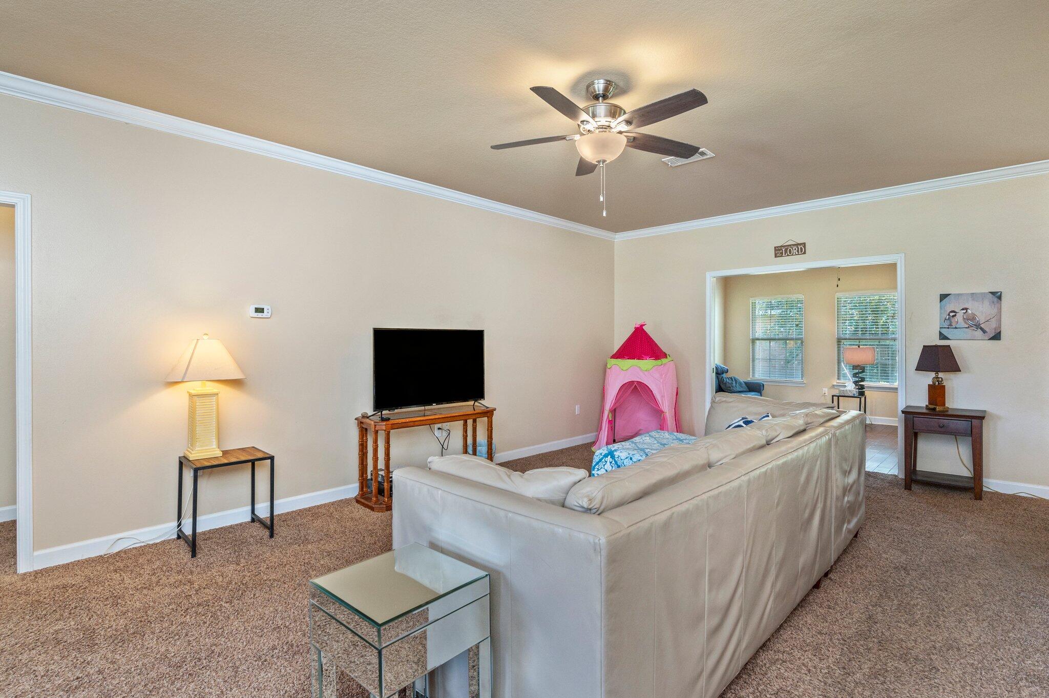 4615 Chanan Drive Crestview, FL 32539 - Photo 11 of 47 a living room with furniture and a flat screen tv