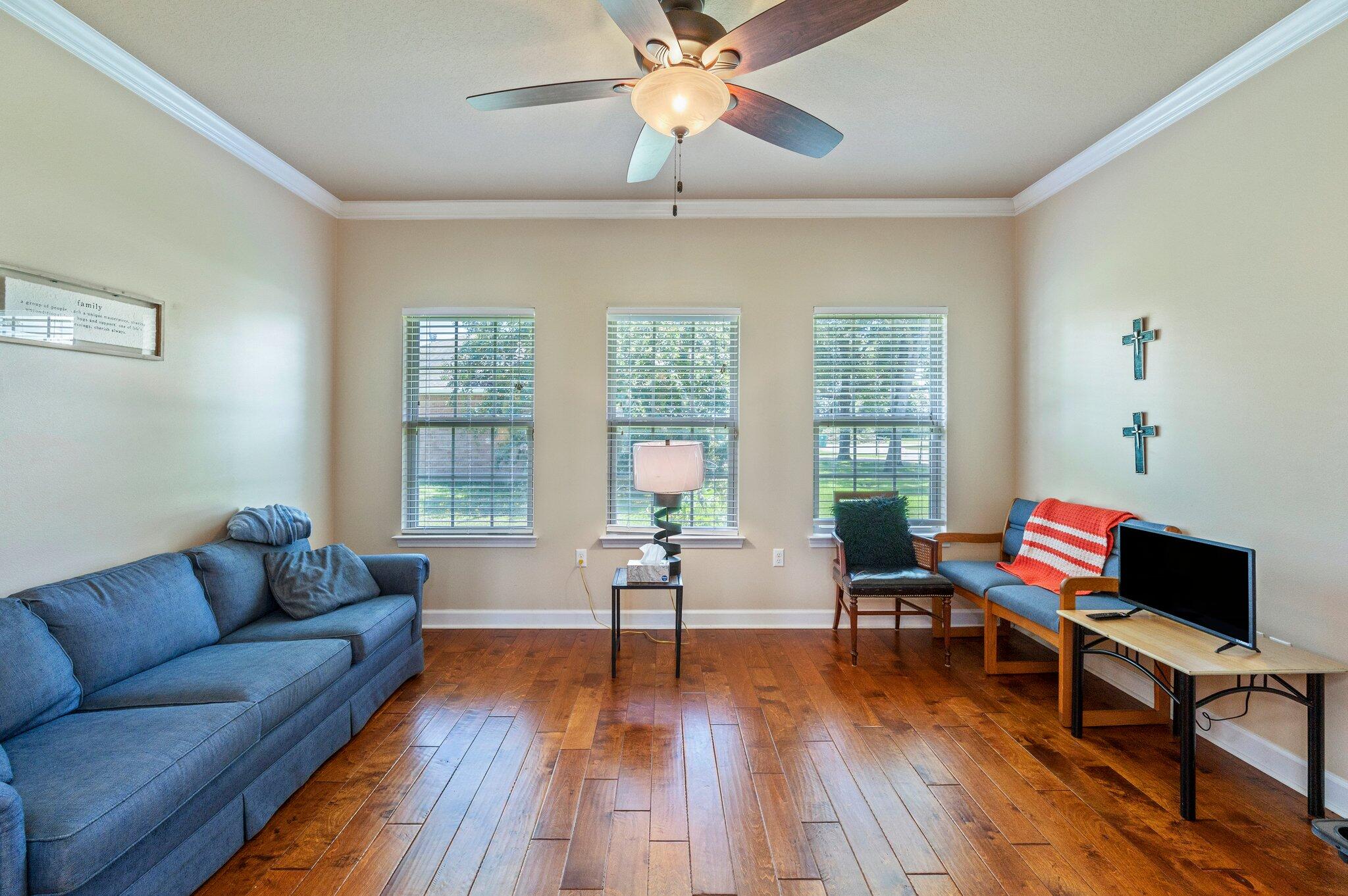 4615 Chanan Drive Crestview, FL 32539 - Photo 13 of 47 a living room with furniture and a wooden floor