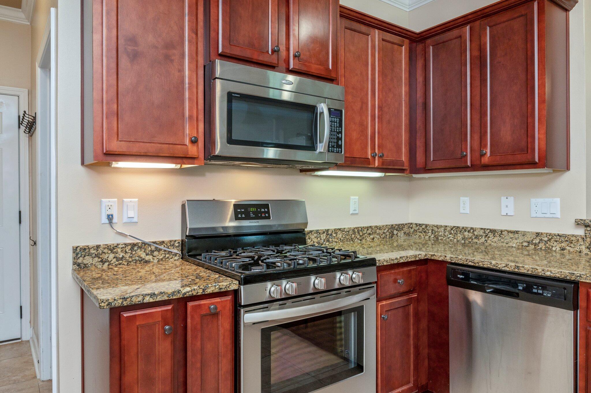4615 Chanan Drive Crestview, FL 32539 - Photo 20 of 47 a kitchen with granite countertop wood cabinets and stainless steel appliances
