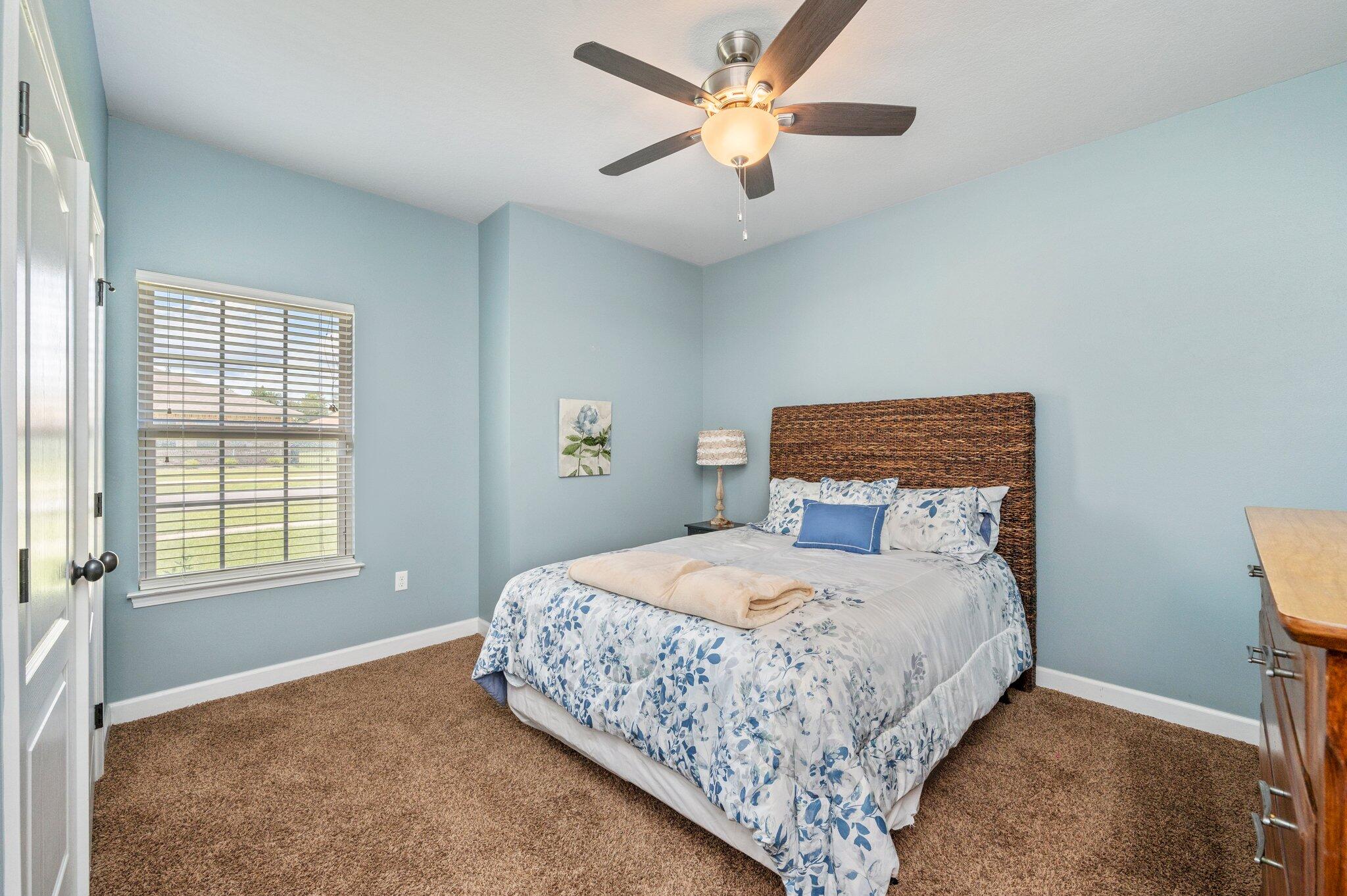 4615 Chanan Drive Crestview, FL 32539 - Photo 22 of 47 a bedroom with a large bed and a window