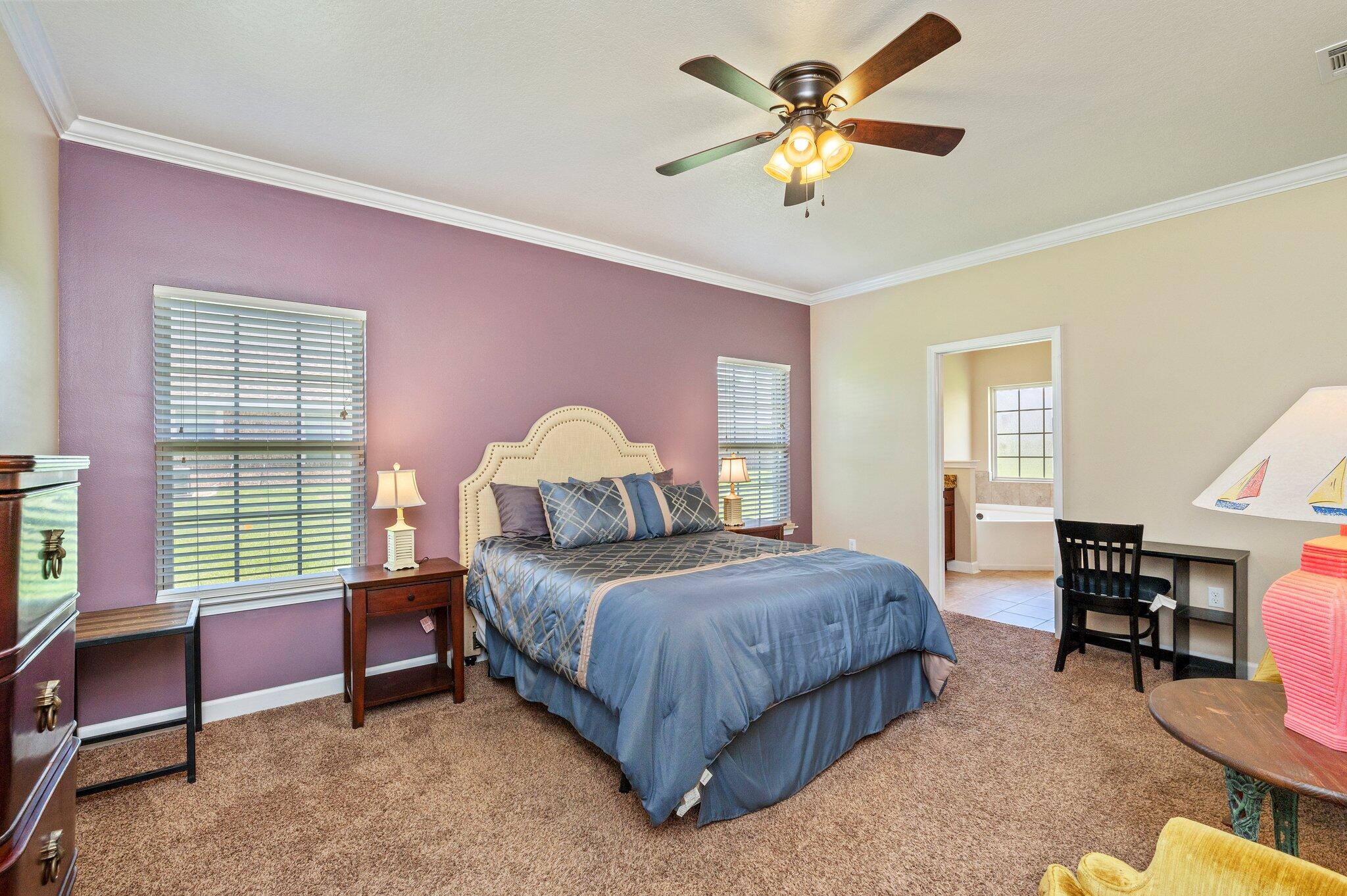 4615 Chanan Drive Crestview, FL 32539 - Photo 24 of 47 a bedroom with a bed a chandelier and a window
