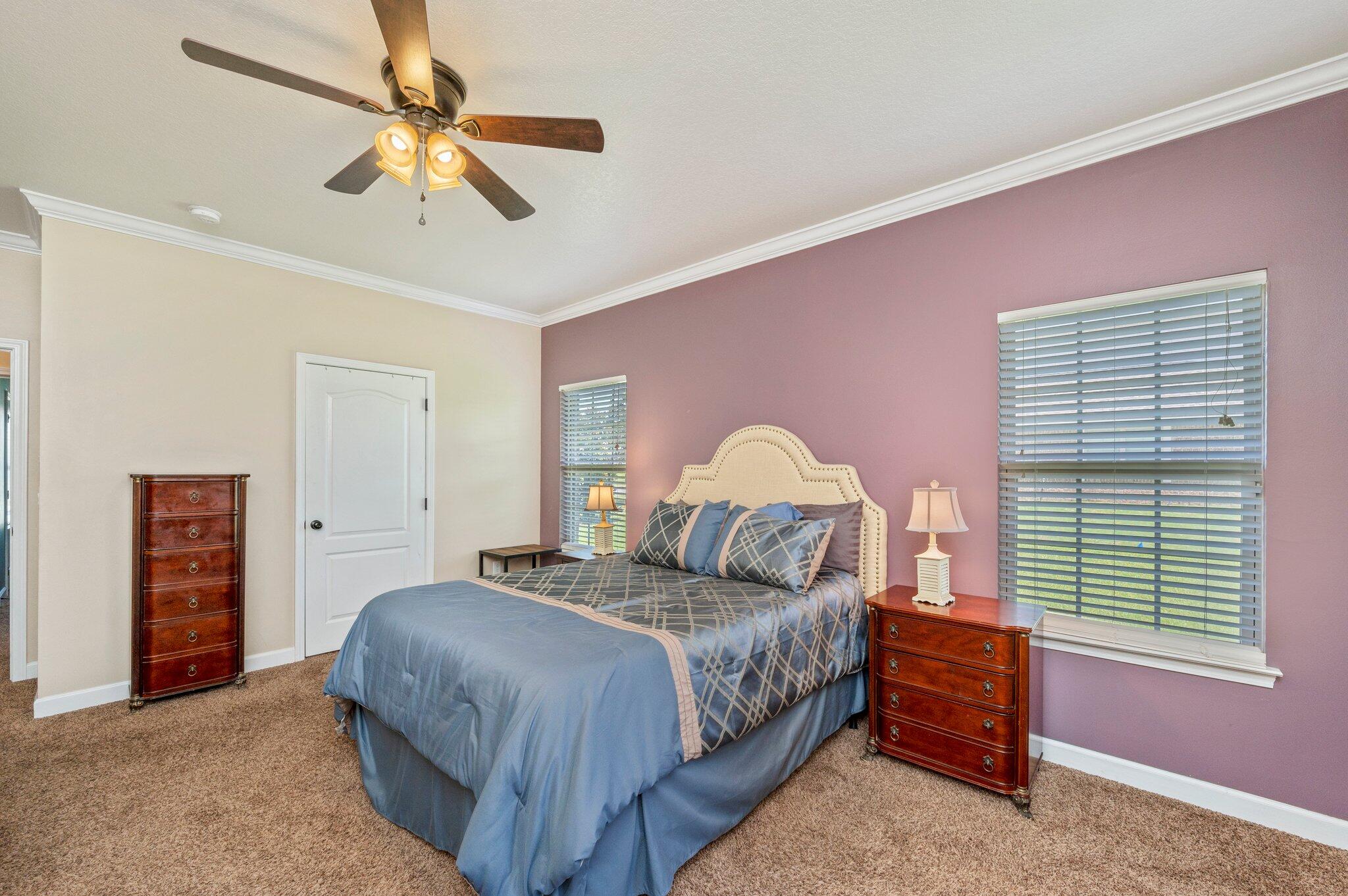 4615 Chanan Drive Crestview, FL 32539 - Photo 25 of 47 a bedroom with a bed and a chandelier
