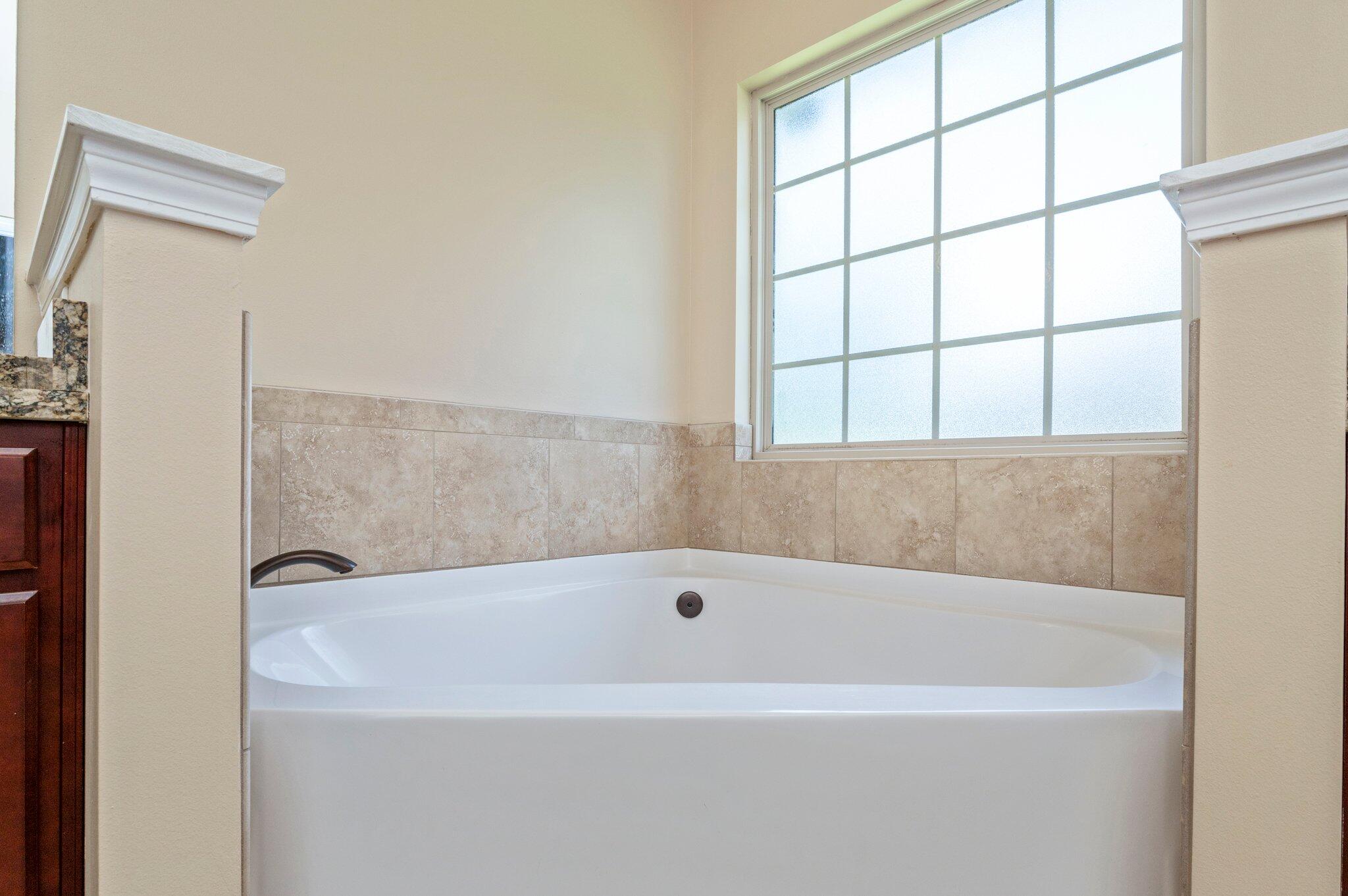 4615 Chanan Drive Crestview, FL 32539 - Photo 29 of 47 a white bath tub sitting next to a window