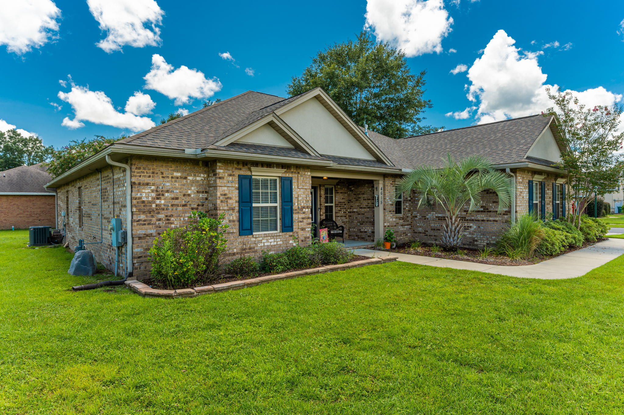 4615 Chanan Drive Crestview, FL 32539 - Photo 3 of 47 a front view of a house with a garden and plants