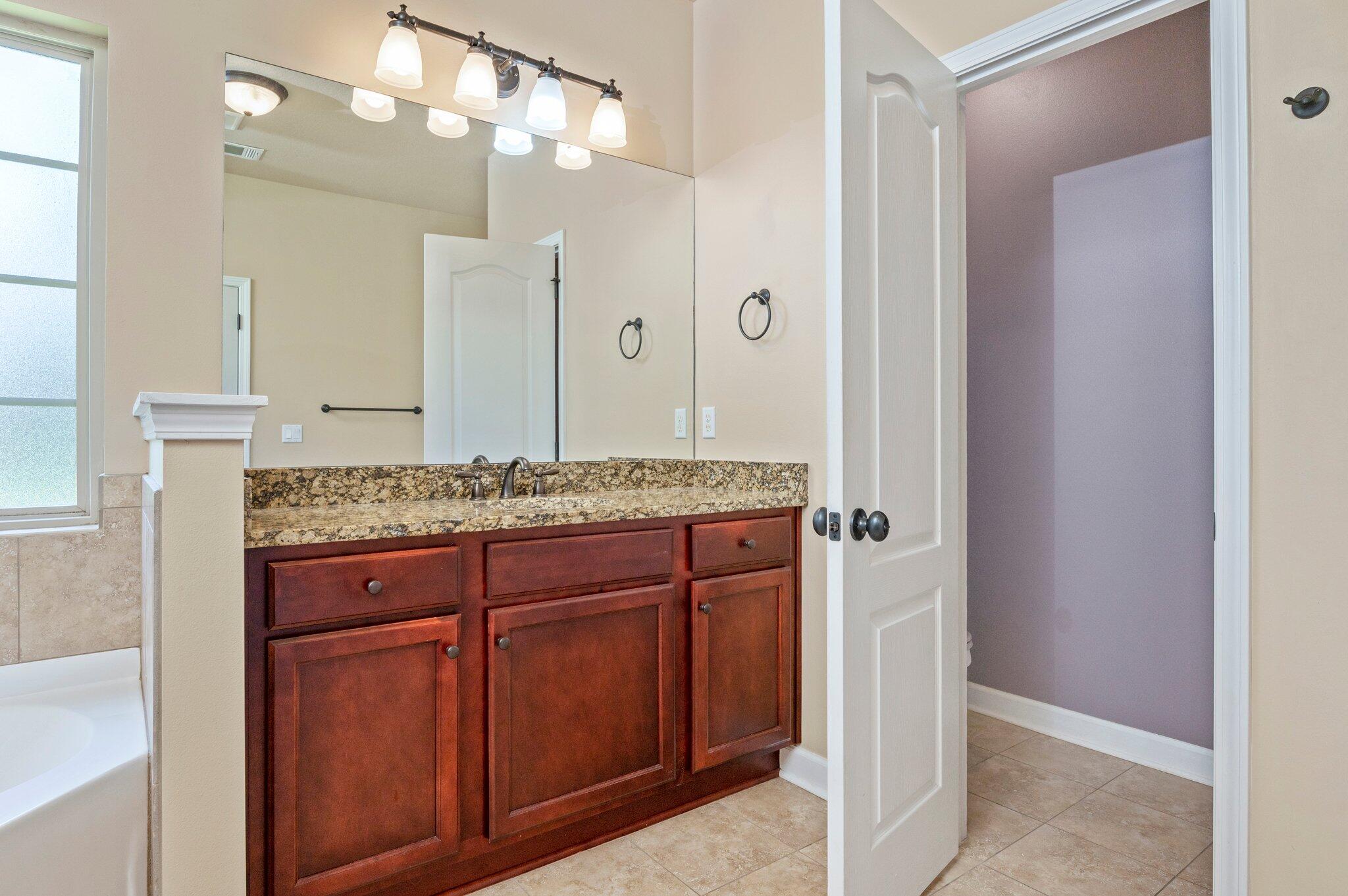 4615 Chanan Drive Crestview, FL 32539 - Photo 34 of 47 a bathroom with a granite countertop sink and a mirror