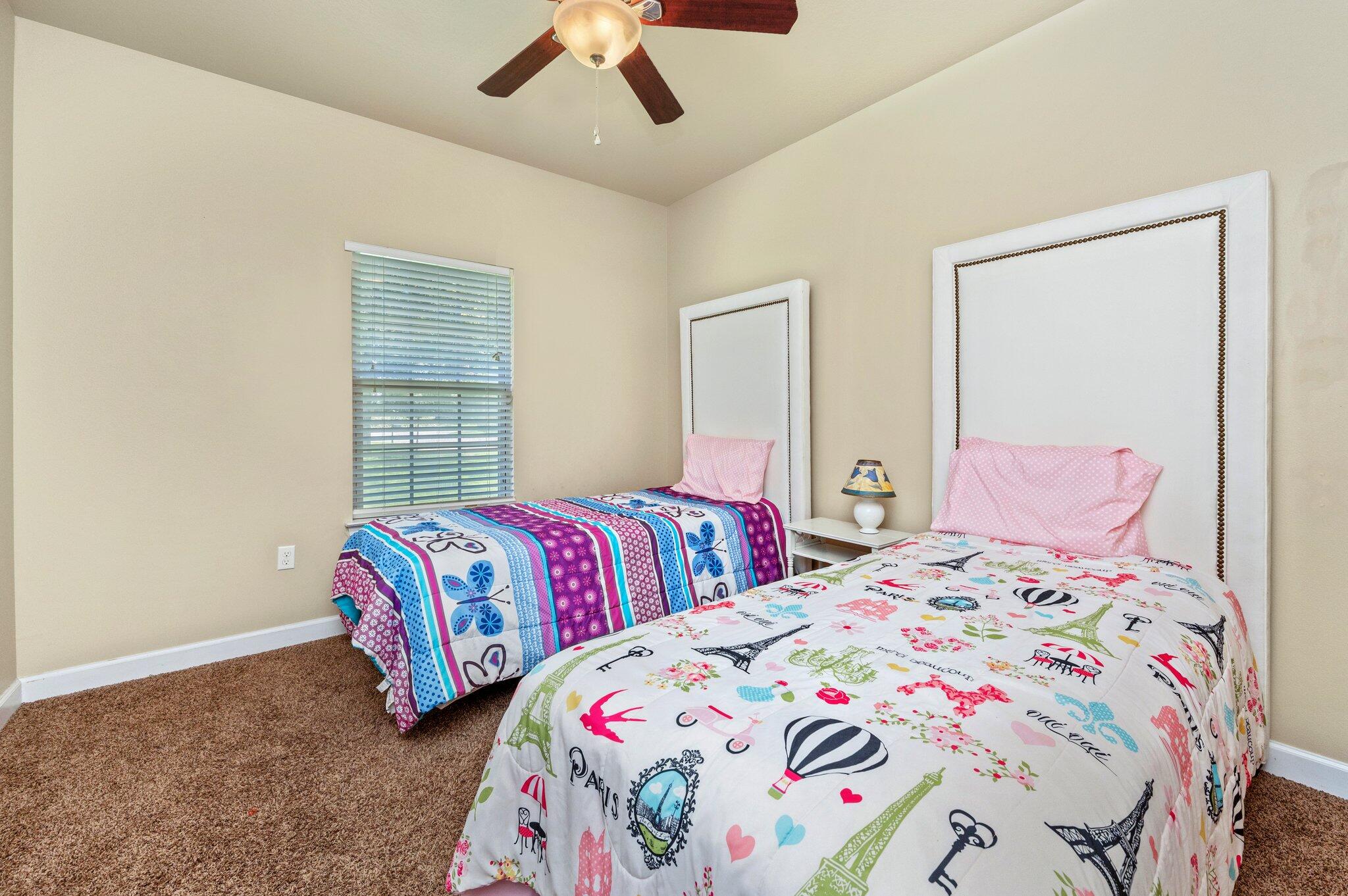 4615 Chanan Drive Crestview, FL 32539 - Photo 35 of 47 a bedroom with two beds and a chandelier