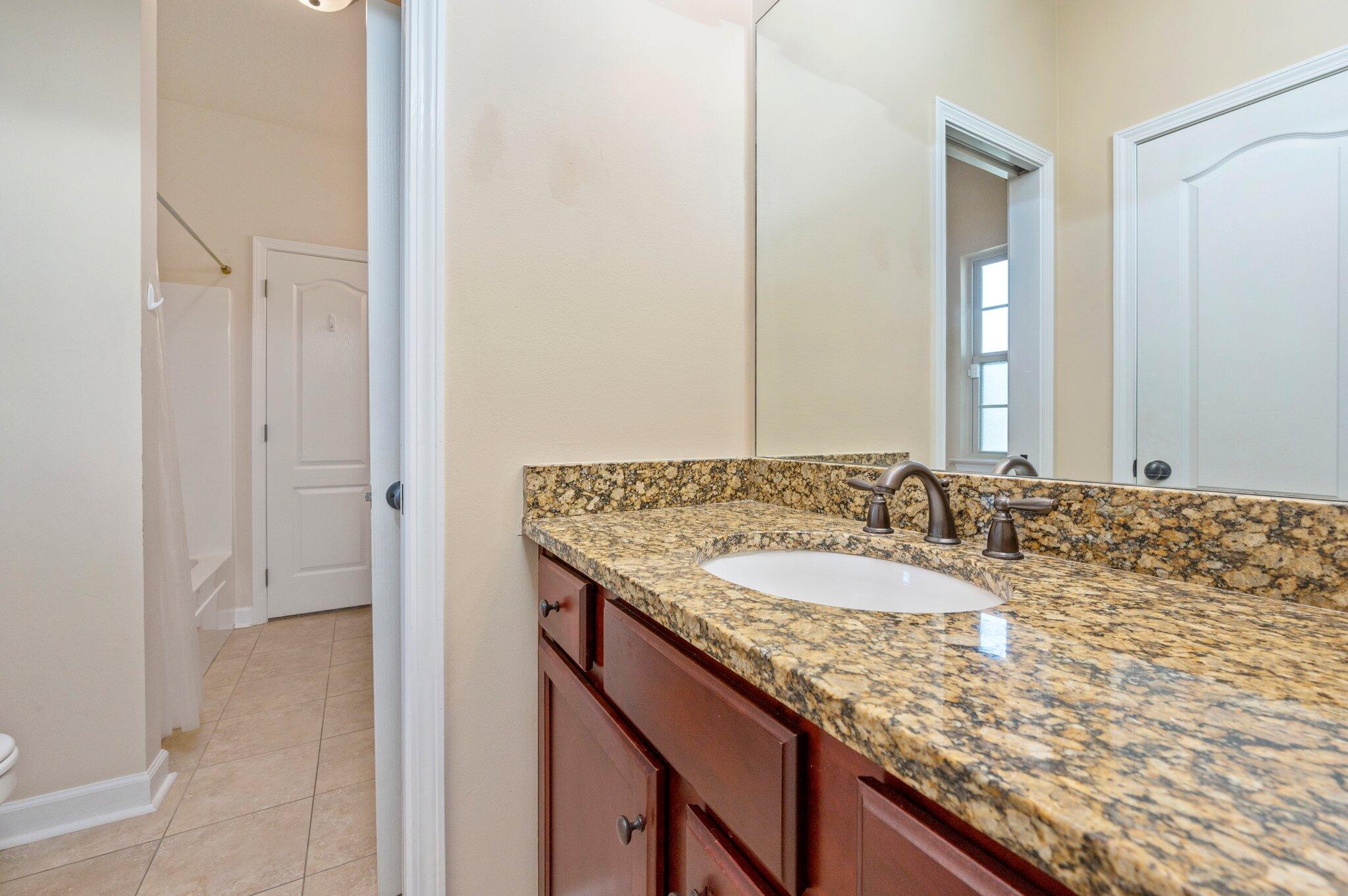 4615 Chanan Drive Crestview, FL 32539 - Photo 37 of 47 a bathroom with a granite countertop sink and a mirror