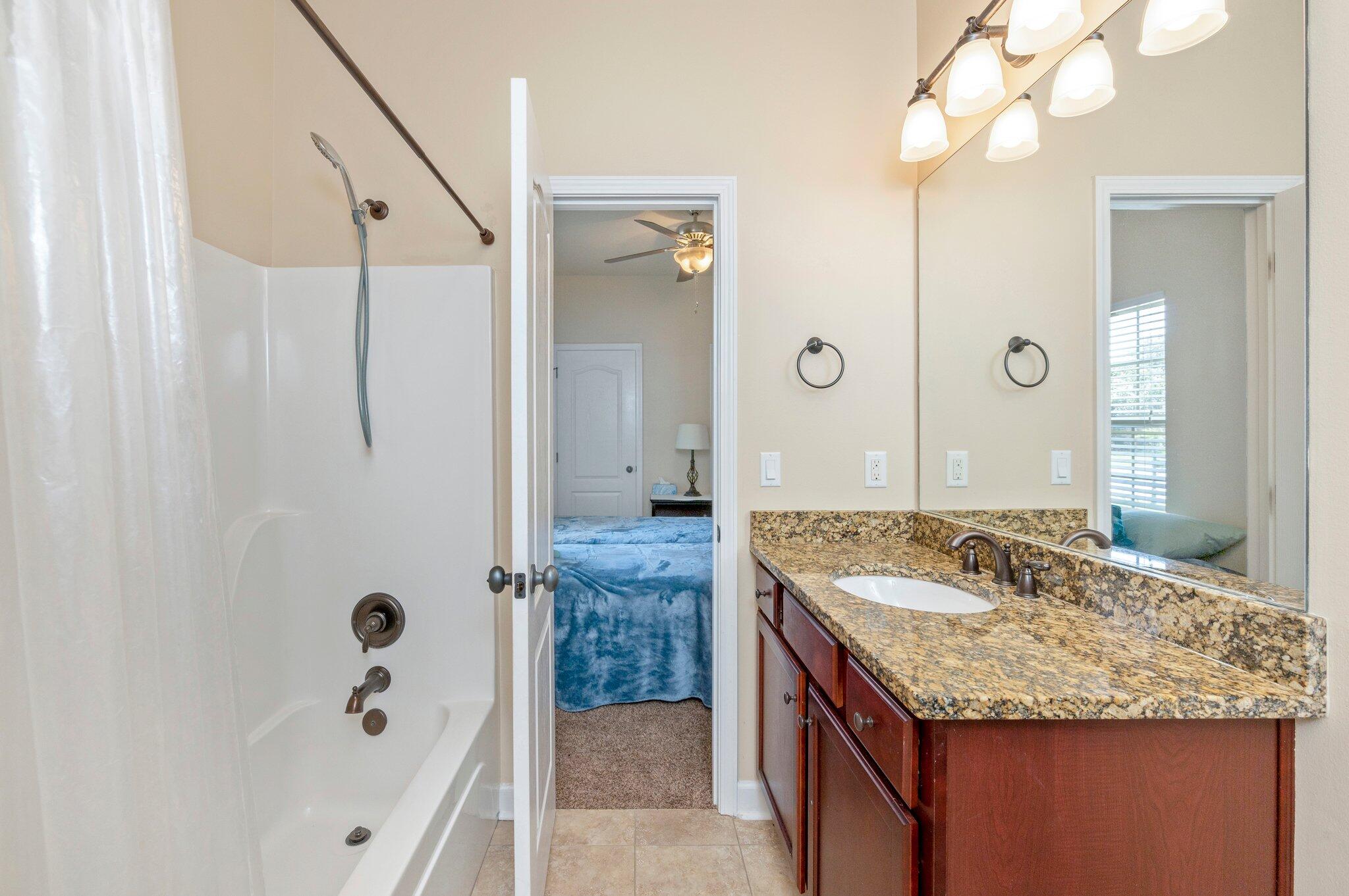 4615 Chanan Drive Crestview, FL 32539 - Photo 38 of 47 a bathroom with a granite countertop sink and a mirror
