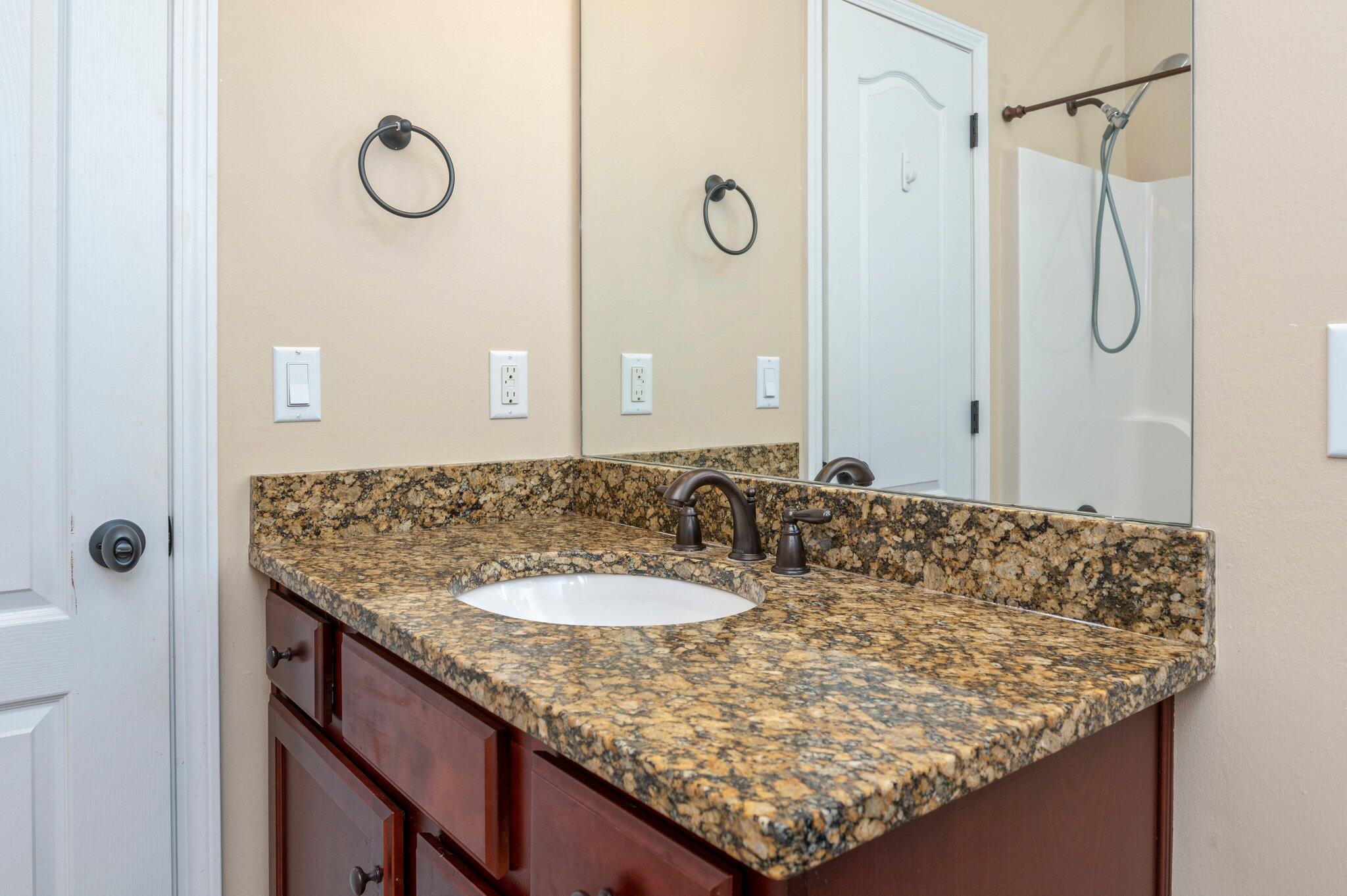 4615 Chanan Drive Crestview, FL 32539 - Photo 40 of 47 a bathroom with a granite countertop sink and a mirror