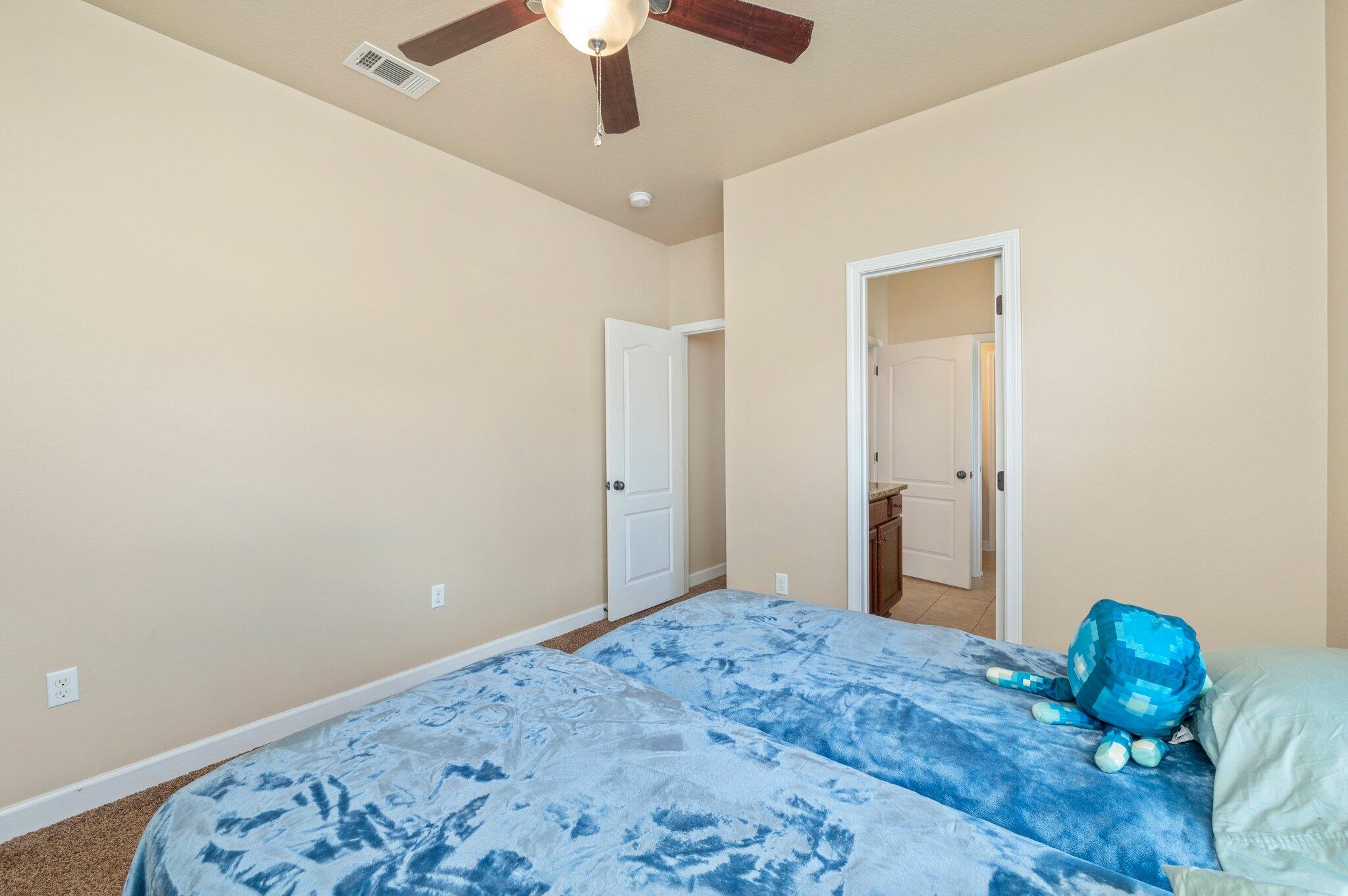 4615 Chanan Drive Crestview, FL 32539 - Photo 42 of 47 a bedroom with a bed and a chandelier fan
