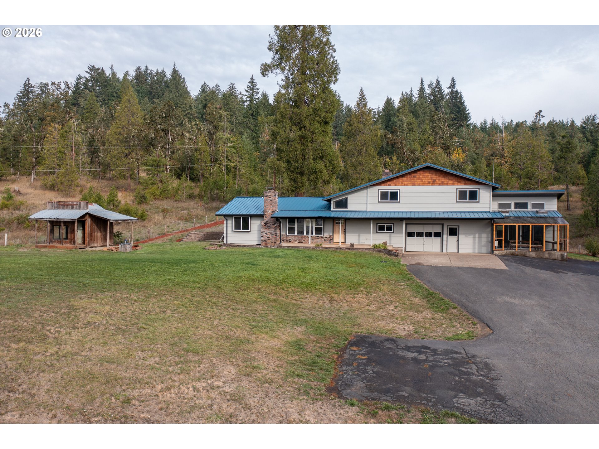 37075 Camp Creek Road Springfield, OR 97478 - Photo 2 of 48 a view of a house with a big yard and large trees