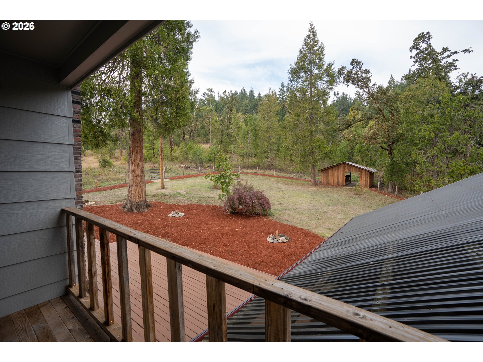 37075 Camp Creek Road Springfield, OR 97478 - Photo 27 of 48 a view of a wooden deck and a backyard