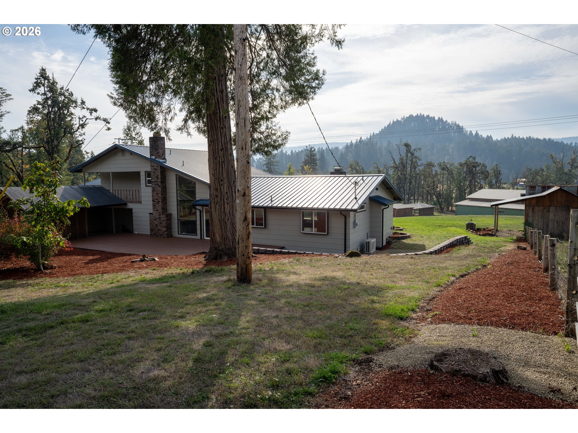 37075 Camp Creek Road Springfield, OR 97478 - Photo 28 of 48 a view of a house with a yard and a large tree