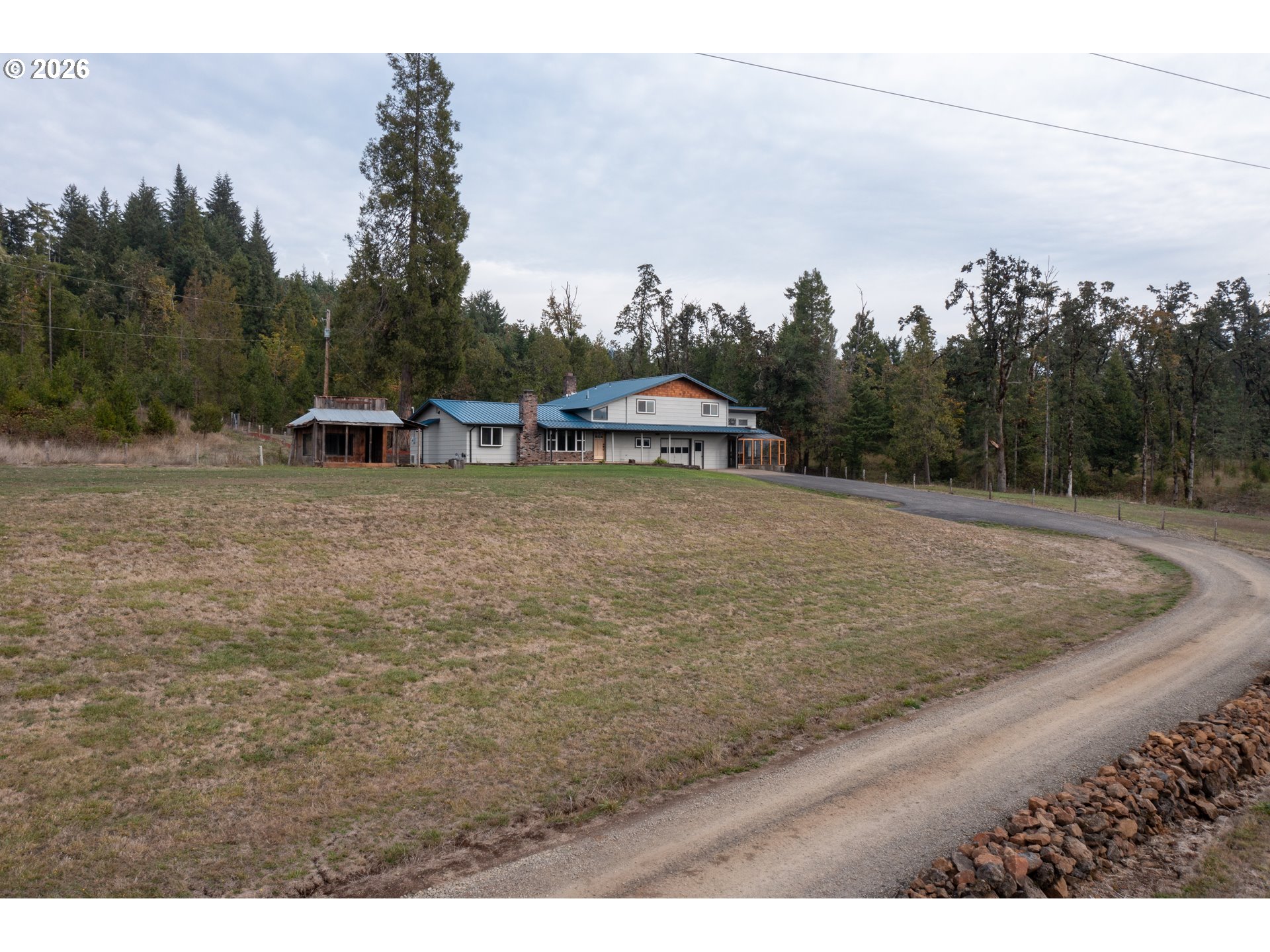 37075 Camp Creek Road Springfield, OR 97478 - Photo 3 of 48 a view of a dry yard with trees in the background