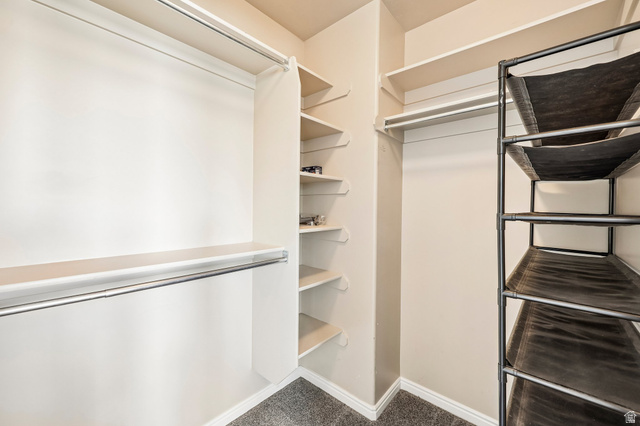 3215 West 450 North West Point, UT 84015 - Photo 18 of 40 Spacious closet featuring multiple hanging rods, built-in shelving, and neutral wall paint
