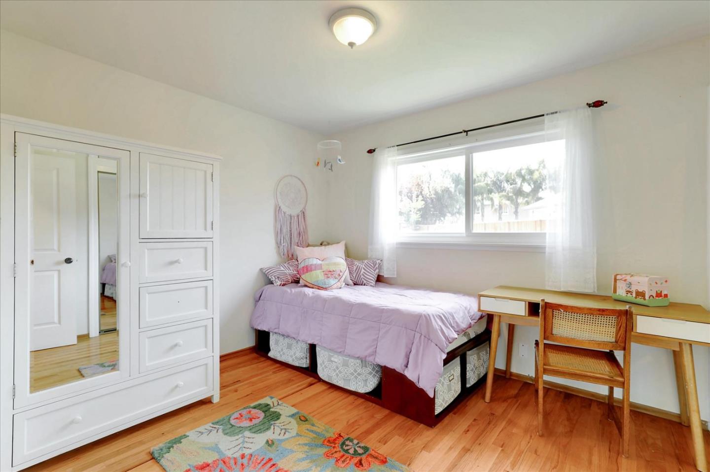 970 Stonehurst Way Campbell, CA 95008 - Photo 14 of 21 a bedroom with a bed and a table in it