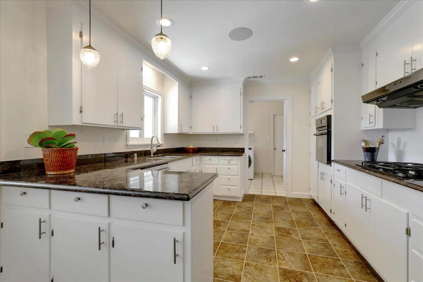 970 Stonehurst Way Campbell, CA 95008 - Photo 7 of 21 a kitchen with kitchen island granite countertop a sink a counter space appliances and cabinets