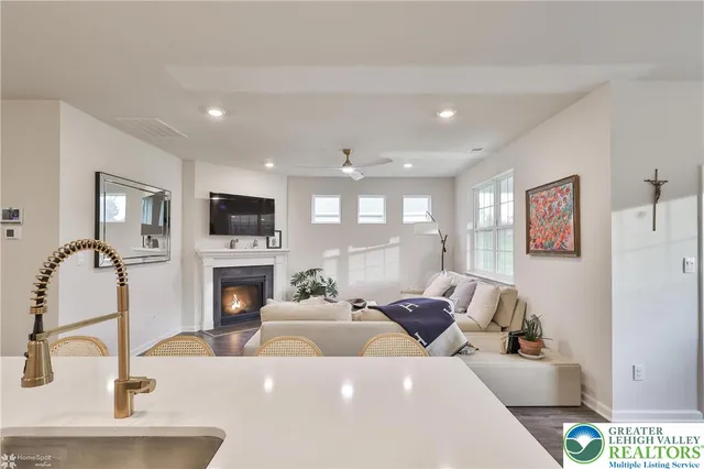 a dining room with furniture a chandelier and wooden floor