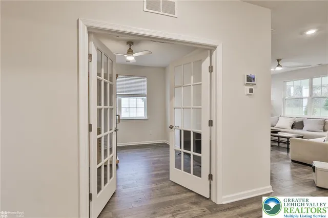 a bathroom with a sink a toilet a mirror and shower