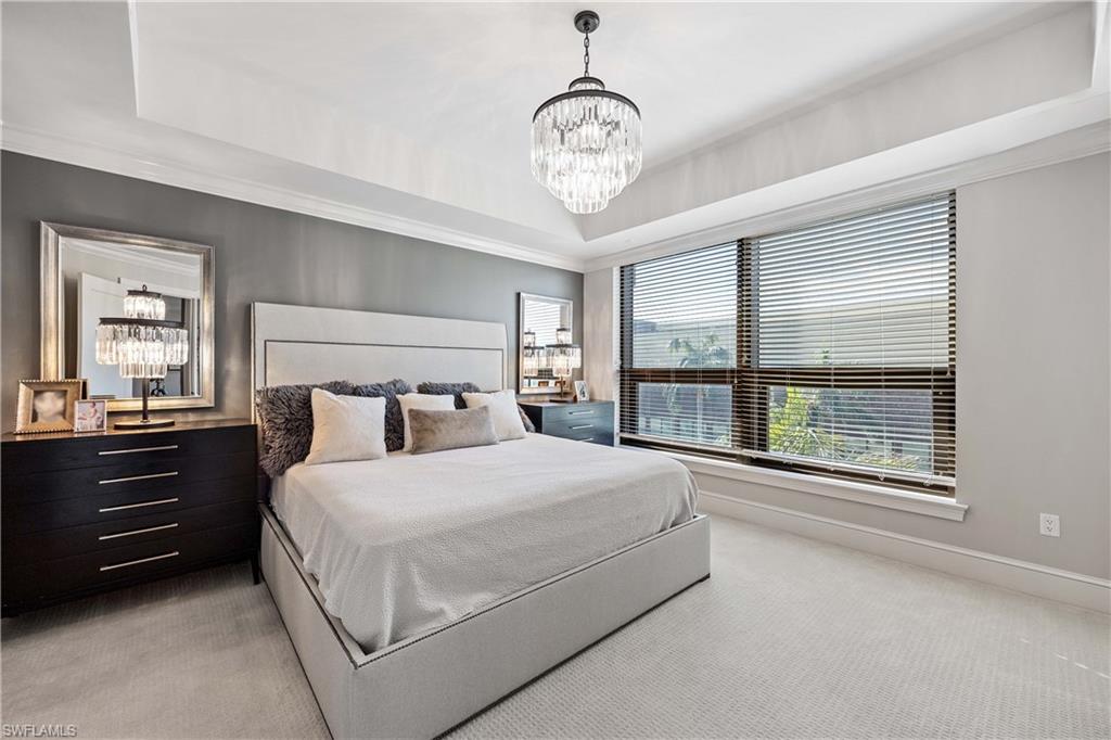9123 Strada Place, Unit 7404 Naples, FL 34108 - Photo 11 of 36 a bedroom with a large bed and a large window