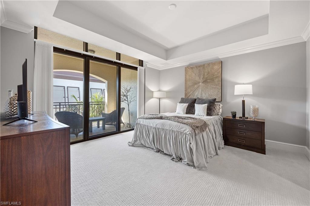 9123 Strada Place, Unit 7404 Naples, FL 34108 - Photo 15 of 36 a bedroom with a large bed and a large window