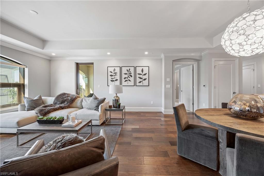 9123 Strada Place, Unit 7404 Naples, FL 34108 - Photo 4 of 36 a living room with furniture and wooden floor