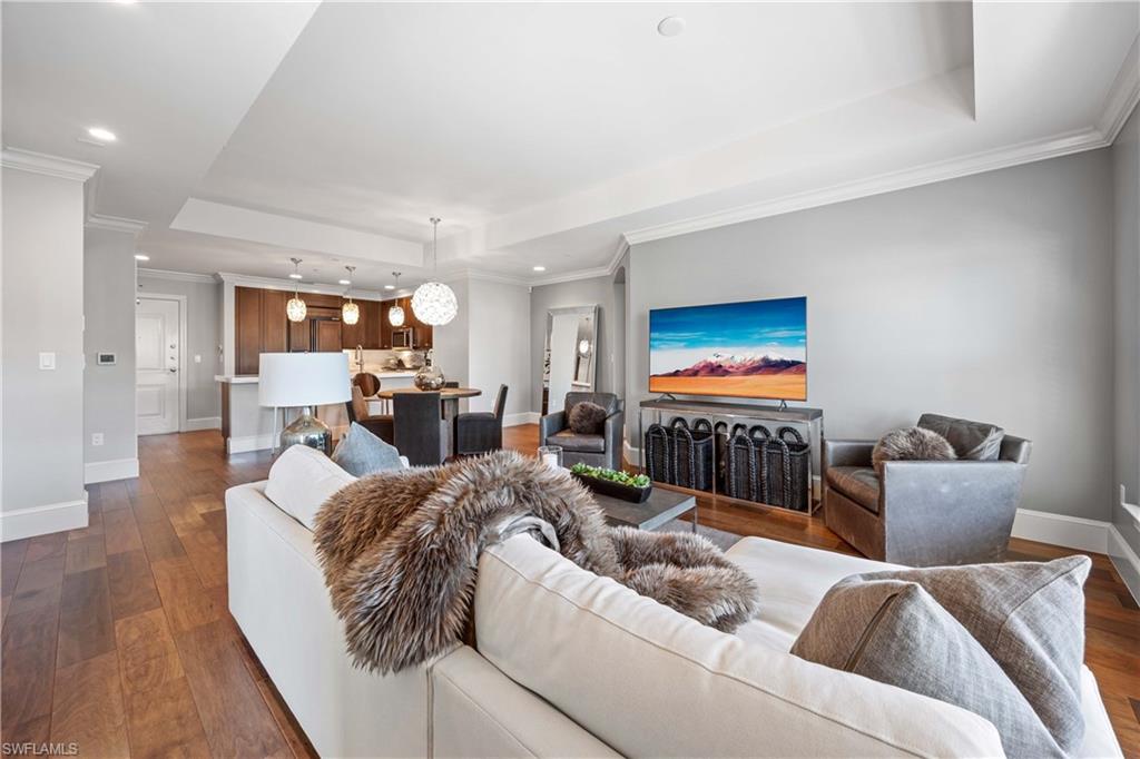 9123 Strada Place, Unit 7404 Naples, FL 34108 - Photo 5 of 36 a living room with furniture and a flat screen tv