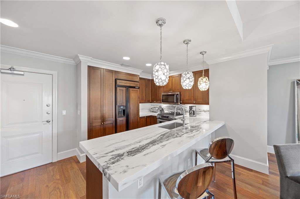 9123 Strada Place, Unit 7404 Naples, FL 34108 - Photo 7 of 36 a view of a kitchen and dining room
