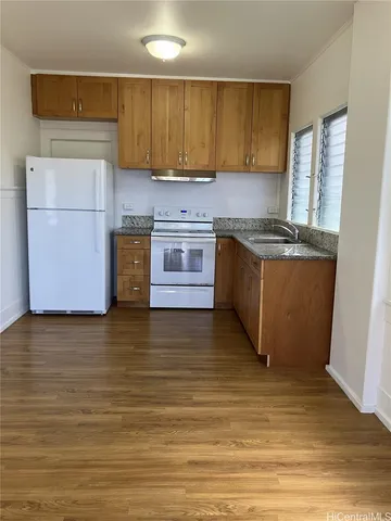 a kitchen with stainless steel appliances granite countertop a stove a sink and a refrigerator