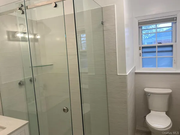a bathroom with a toilet and a shower