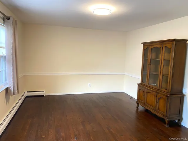 an empty room with wooden floor