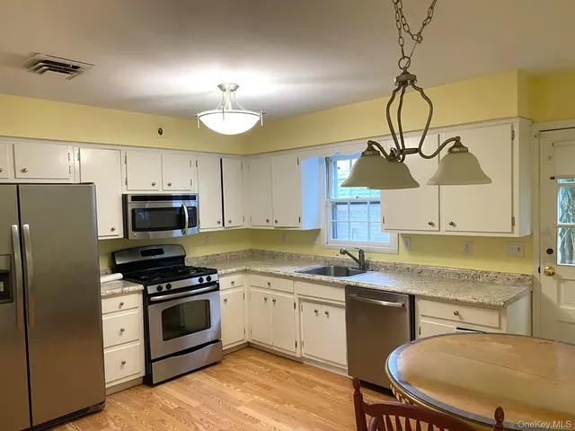a kitchen with a stove a sink and a refrigerator