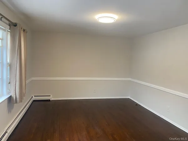 a view of a room with wooden floor and windows in a room