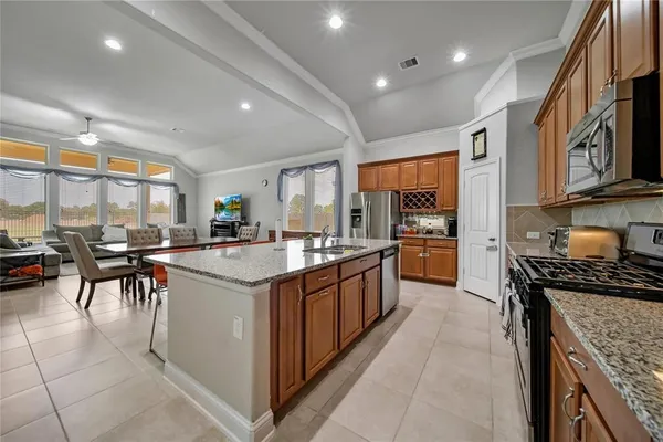 a kitchen with stainless steel appliances granite countertop a sink and a stove