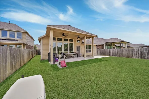 a view of a house with backyard and porch