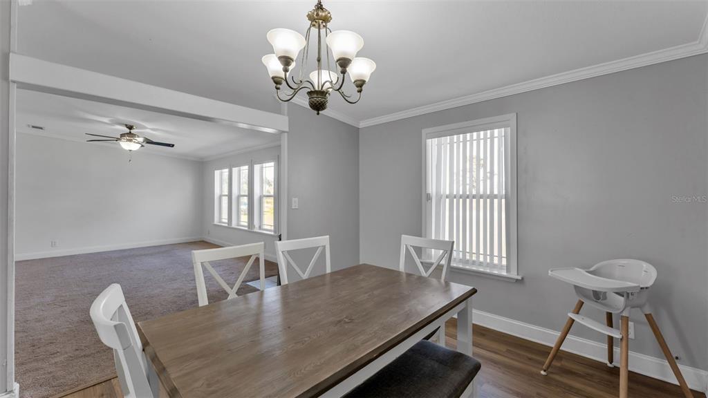 7549 Sinkhole Road Bartow, FL 33830 - Photo 19 of 40 a view of a dining room with furniture window and wooden floor