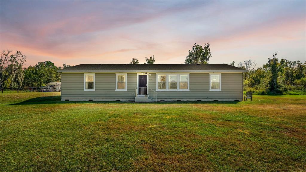 7549 Sinkhole Road Bartow, FL 33830 - Photo 2 of 40 a view of a house with a backyard