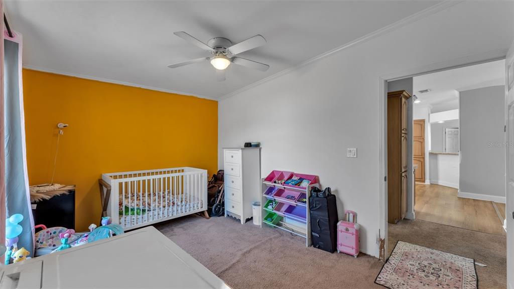 7549 Sinkhole Road Bartow, FL 33830 - Photo 27 of 40 a bedroom with a bed and a chandelier