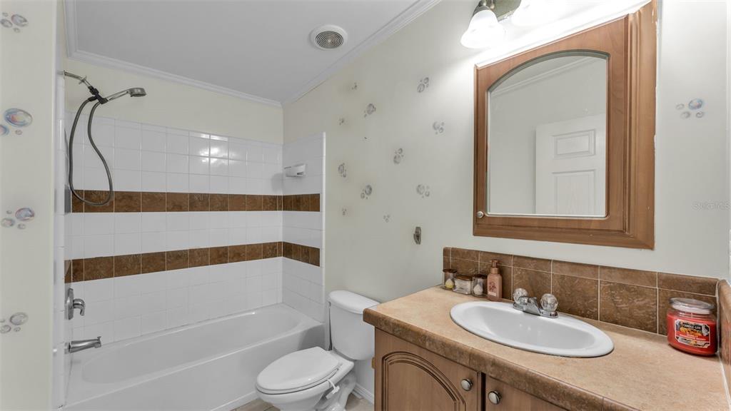 7549 Sinkhole Road Bartow, FL 33830 - Photo 29 of 40 a bathroom with a sink toilet a shower and a mirror