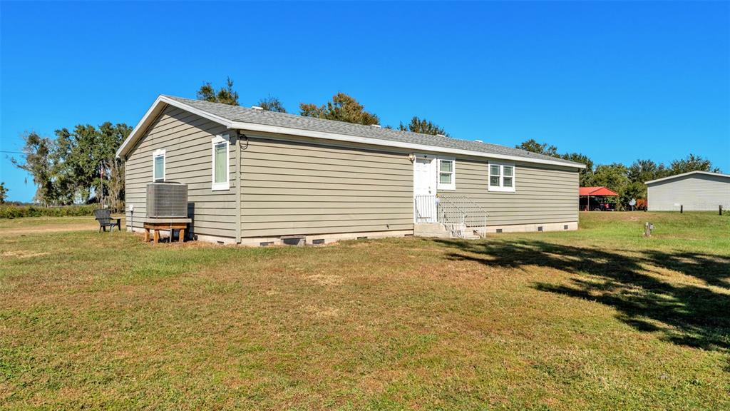 7549 Sinkhole Road Bartow, FL 33830 - Photo 3 of 40 a view of a backyard with a garden and plants