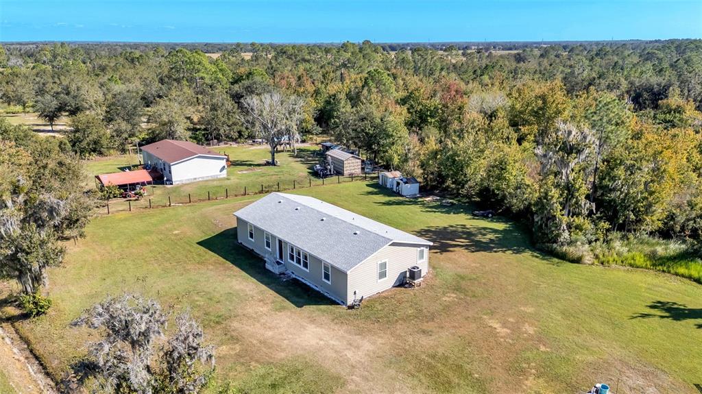7549 Sinkhole Road Bartow, FL 33830 - Photo 39 of 40 a view of a swimming pool and trees in the background