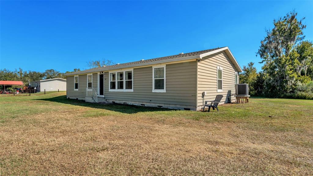 7549 Sinkhole Road Bartow, FL 33830 - Photo 4 of 40 a view of a house with backyard and sitting area