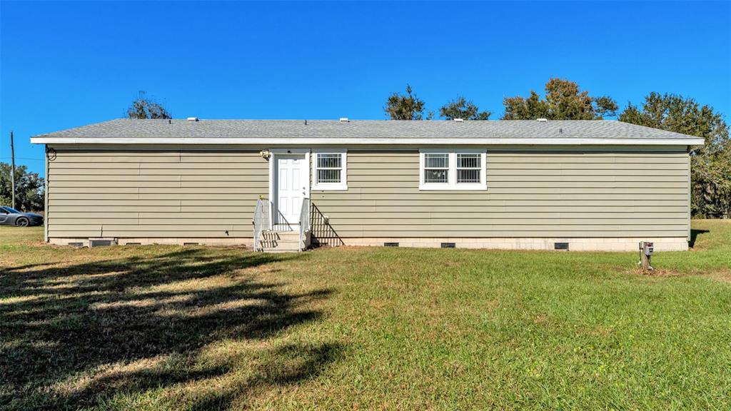 7549 Sinkhole Road Bartow, FL 33830 - Photo 5 of 40 a front view of a house with a yard