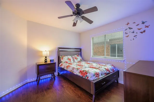 a bedroom with a bed table and chair